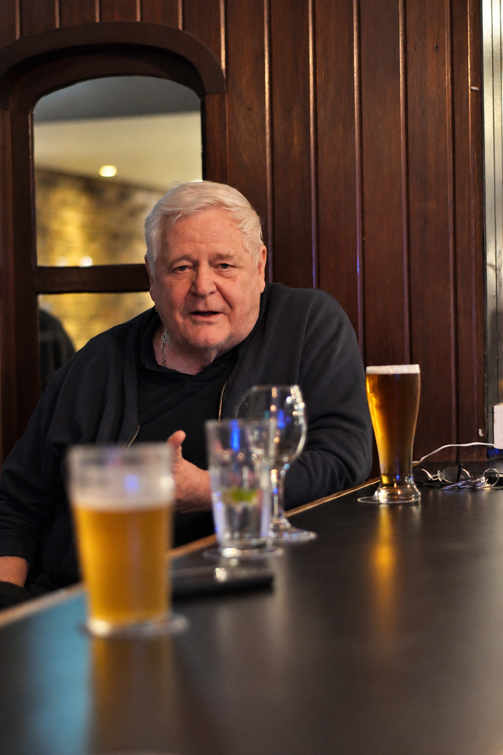 Candid portrait of a man seated at a pub table